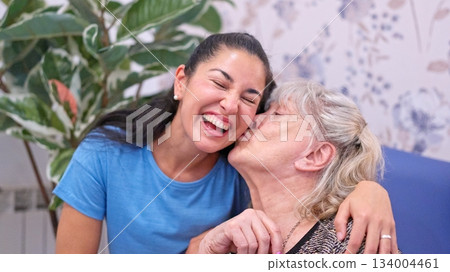 Granddaughter and grandmother sharing happy loving moment Granddaughter and grandmother sharing happy loving moment 134004461