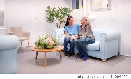 Granddaughter showing care for grandmother in nursing home 134004491