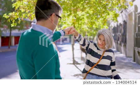 Senior couple dancing and smiling together 134004514