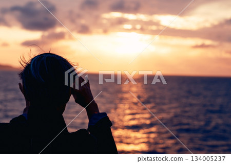 A dramatic silhouette scene illuminated by strong backlighting A dramatic silhouette scene illuminated by strong backlighting 134005237