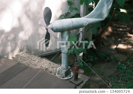 The nostalgia of an old propeller and the silence created by greenery and shadows The nostalgia of an old propeller and the silence created by greenery and shadows 134005724