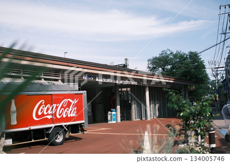 In front of Inokashira Park Station under a blue sky. A vibrant red adds color to everyday life. In front of Inokashira Park Station under a blue sky. A vibrant red adds color to everyday life. 134005746