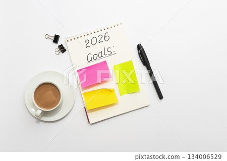 Minimal workspace with notebook, colorful sticky notes, pen, binder clips and coffee cup on white background, top view Minimal workspace with notebook, colorful sticky notes, pen, binder clips and coffee cup on white background, top view 134006529