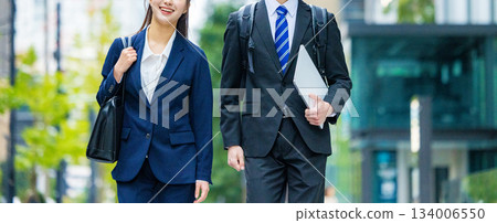 Walking business woman and businessman Walking business woman and businessman 134006550