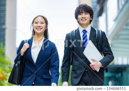 Walking business woman and businessman 134006551