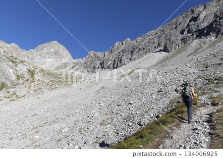 Hikers on the trail to Schesaplana in Vorarlberg Austria during a sunny day in the Ratikon mountain range 134006925