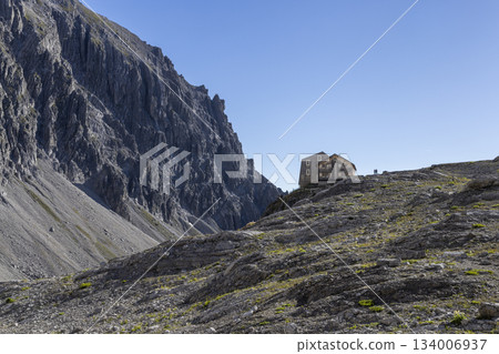View of Totalp-Hutte in the Ratikon mountain range during a hike to Schesaplana in Vorarlberg, Austria surrounded by rocky terrain 134006937