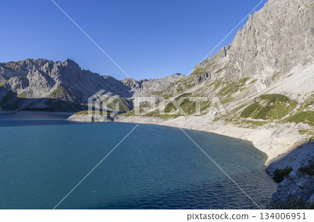 Hiking to Schesaplana with view at Lunersee lake in Ratikon mountain range, Vorarlberg, Austria during a clear day Hiking to Schesaplana with view at Lunersee lake in Ratikon mountain range, Vorarlberg, Austria during a clear day 134006951
