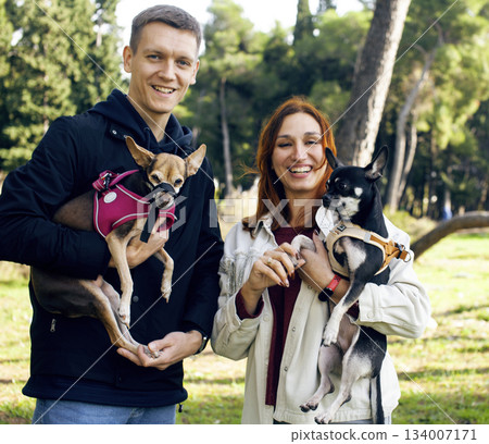 young couple walking with dogs, lifestyle people concept 134007171