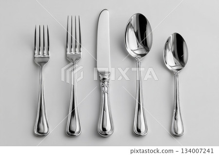 Luxury home decor. Full silverware set. Including soup spoon, dinner fork, knife, dessert fork and teaspoon, perfectly arranged on a white background. Formal dining settings Luxury home decor. Full silverware set. Including soup spoon, dinner fork, knife, dessert fork and teaspoon, perfectly arranged on a white background. Formal dining settings 134007241