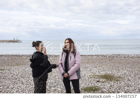 two girls friends walking together outside, lifestyle people concept 134007257