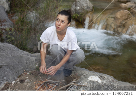 young pretty brunette girl hiking to waterfall, lifestyle people concept young pretty brunette girl hiking to waterfall, lifestyle people concept 134007281