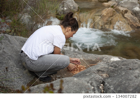 young pretty brunette girl hiking to waterfall, lifestyle people concept 134007282