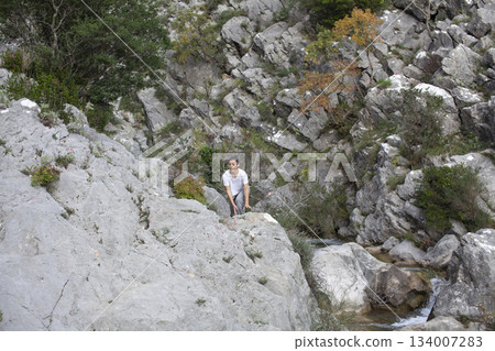 young pretty brunette girl hiking to waterfall, lifestyle people concept 134007283