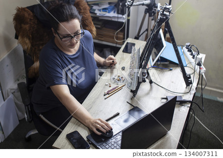 mature woman painter in studio doing online education lesson, lifestyle people concept 134007311