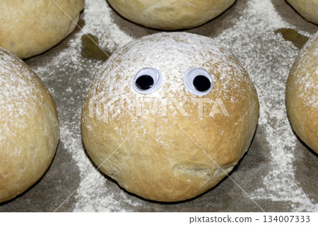 A Funny Freshly Home Made Baked Bread Roll With Googly Wobble Eyes A Funny Freshly Home Made Baked Bread Roll With Googly Wobble Eyes 134007333