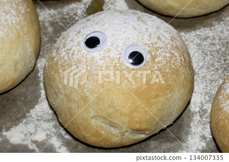 A Funny Freshly Home Made Baked Bread Roll With Googly Wobble Eyes A Funny Freshly Home Made Baked Bread Roll With Googly Wobble Eyes 134007335
