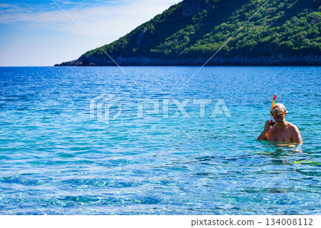 Man with snorkeling tube in sea Man with snorkeling tube in sea 134008112