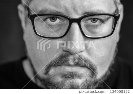 Portrait of young Caucasian man with glasses, beard on black. Portrait of young Caucasian man with glasses, beard on black. 134008132