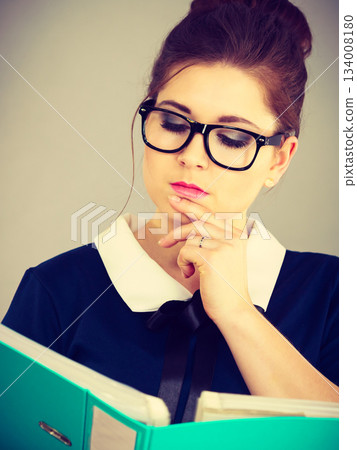 woman thinking holds file folder with documents woman thinking holds file folder with documents 134008180