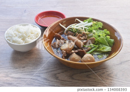 boiled braised beef meat and tendon couple organ in herb brown soup on bowl dipping spicy chili sauce eat couple with plain rice boiled braised beef meat and tendon couple organ in herb brown soup on bowl dipping spicy chili sauce eat couple with plain rice 134008393