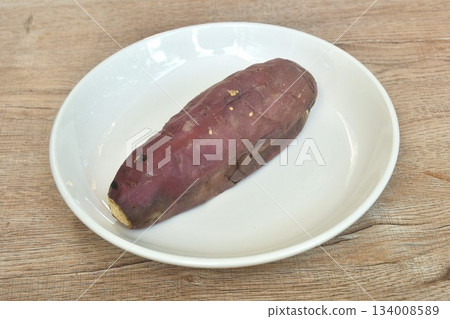 grilled Japanese purple yam with peel arranging on plate  134008589