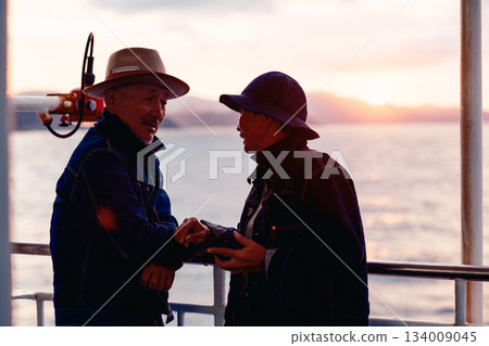 Portrait of a senior couple embracing each other on a boat at sunset 134009045