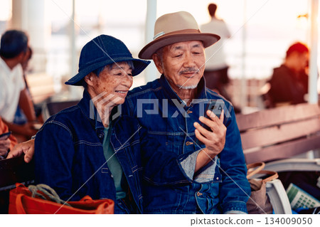 Portrait of a senior couple embracing each other on a boat at sunset 134009050