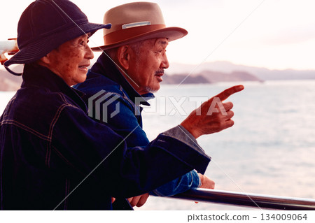 Portrait of a senior couple embracing each other on a boat at sunset 134009064