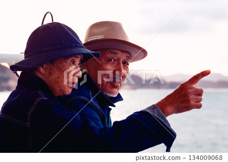 Portrait of a senior couple embracing each other on a boat at sunset 134009068