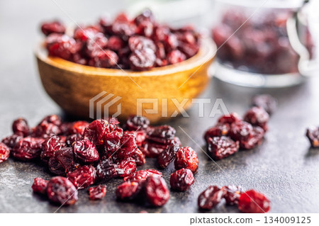 Tasty dried cranberries on black table. Tasty dried cranberries on black table. 134009125