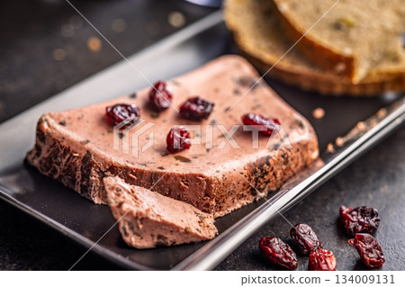 Liver pate with cranberries on black plate. Liver pate with cranberries on black plate. 134009131