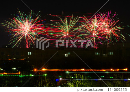 Festive Christmas and New Year's fireworks. Against the backdrop of a night city. Festive atmosphere. Festive Christmas and New Year's fireworks. Against the backdrop of a night city. Festive atmosphere. 134009253