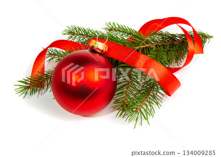 A matte Christmas tree ball with a red ribbon and a fir branch. New Year's and Christmas elements on a white background. A matte Christmas tree ball with a red ribbon and a fir branch. New Year's and Christmas elements on a white background. 134009285