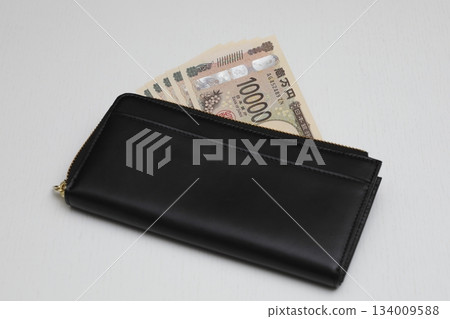 Black wallet and 10,000 yen bill Black wallet and 10,000 yen bill 134009588
