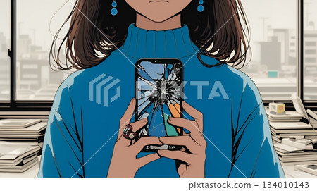 A young woman holding a smartphone with a broken screen 134010143