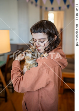 Lonely teenage girl tender hugging embrace purring adorable cat exchanging kindness caring affection 134010411