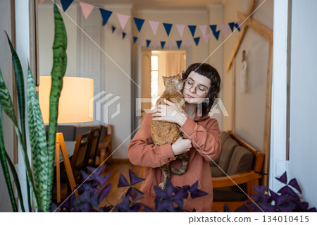 Girl ret owner holding in hands pedigree cat Devon Rex. Antistress, tactile therapy, empathy to pets 134010415