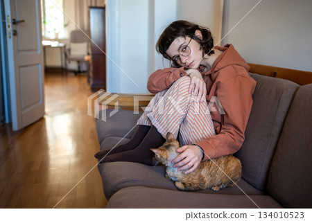 Loving pet owner feeling lonely, stressed stroking cat in need of emotional support, tactile contact 134010523