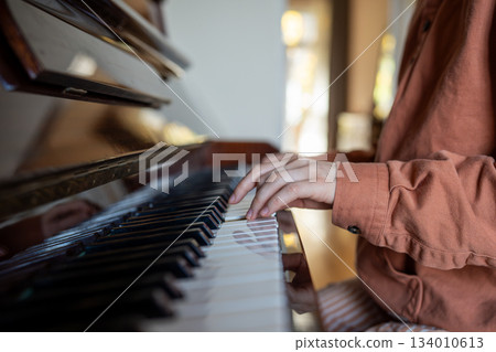 Hands of woman talented pianist practicing music skills playing piano at home enjoying melody. Hands of woman talented pianist practicing music skills playing piano at home enjoying melody. 134010613
