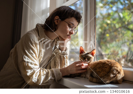 Lonely upset pet owner girl in need of comfort, empathy stroking cat, seeking for emotional support  134010616