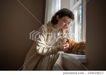 Unhappy thoughtful pet owner girl feeling frustration stroking cat needing emotional psychology help 134010617