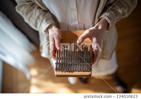 Improvising on ethnic percussion instrument kalimba, sound therapy, relaxation and meditation Improvising on ethnic percussion instrument kalimba, sound therapy, relaxation and meditation 134010623