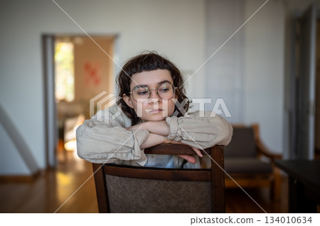 Emotional burnout of young boring woman sitting on chair in sorrow thoughts. Mental problem 134010634