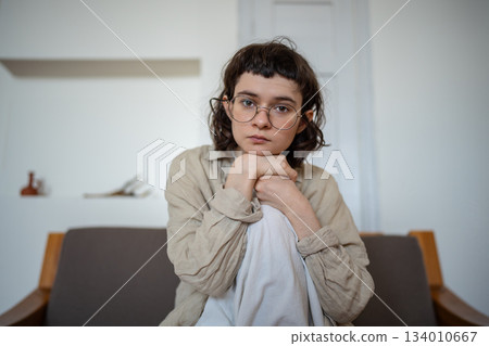 Portrait of pensive teenager looking at camera, thinking of life, future, difficulties, problems 134010667