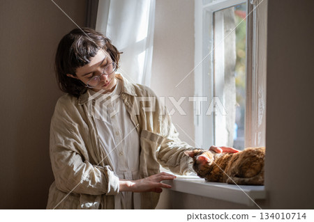 Lonely upset pet owner girl in need of comfort, empathy stroking cat, seeking for emotional support  134010714