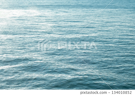 Sea water surface, wave texture. Calm seascape. The background of the blue waters of the sea. Background sea calm water. 134010852