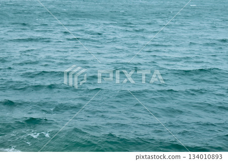 Sea water surface, wave texture. Calm seascape. The background of the blue waters of the sea. Background sea calm water. Sea water surface, wave texture. Calm seascape. The background of the blue waters of the sea. Background sea calm water. 134010893