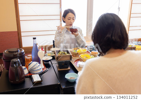 Hotel breakfast: Woman drinking miso soup Hotel breakfast: Woman drinking miso soup 134011252