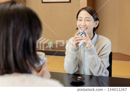 Women's trip, hot spring inn, accommodation room, woman drinking tea Women's trip, hot spring inn, accommodation room, woman drinking tea 134011267